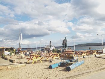 Catamaran and picnic tables on sand beach