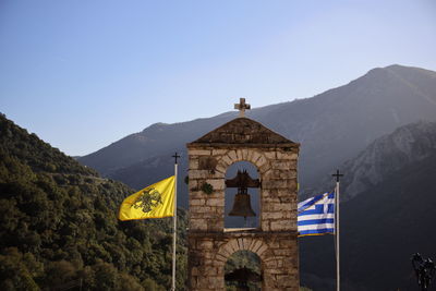 View of bell tower and mountain against sky