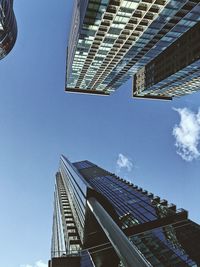 Low angle view of modern buildings against clear blue sky