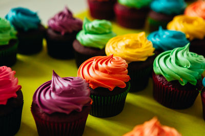 Close-up of colorful cupcakes in tray on table