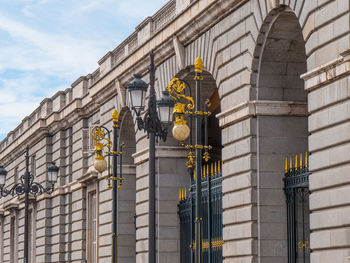 Low angle view of illuminated street light against building