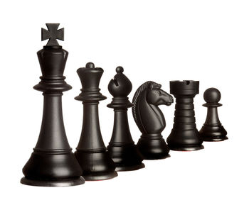 Low angle view of chess board against white background