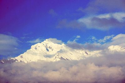 Close-up of snow against blue sky