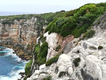 Scenic view of river by rock formation against sky