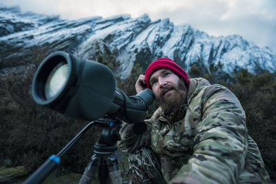 Man looking through monocular