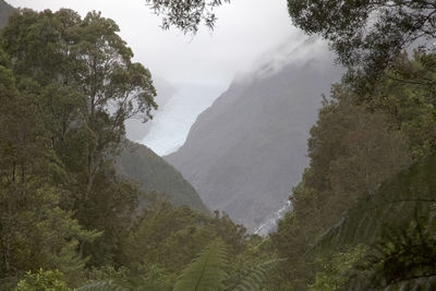 High angle view of waterfall amidst mountains