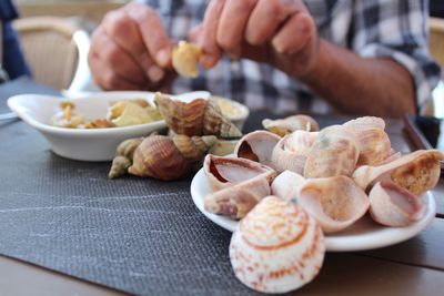 Close-up of hand holding food on table