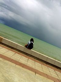 High angle view of people sitting on beach