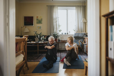 Senior couple doing yoga at home
