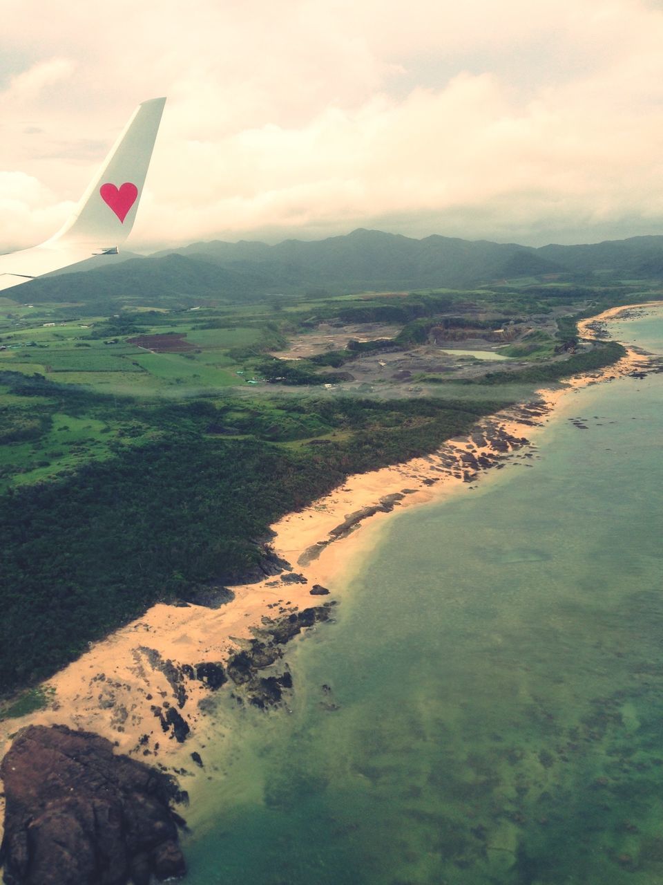 sea, water, sky, transportation, beach, scenics, tranquil scene, landscape, coastline, aerial view, tranquility, mountain, nature, mode of transport, beauty in nature, shore, flying, horizon over water, cloud - sky, high angle view