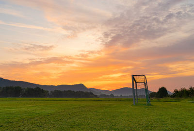 Scenic view of field against sky during sunset