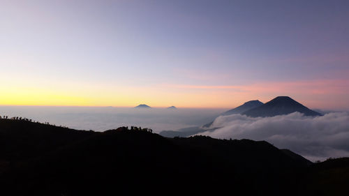 Scenic view of silhouette mountains against sky during sunset