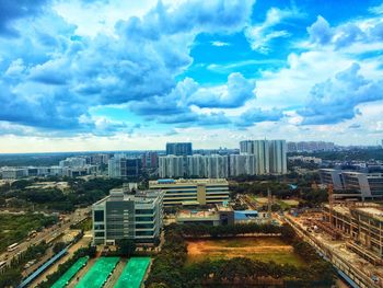 High angle view of cityscape against cloudy sky