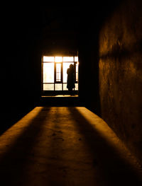 Silhouette man in corridor of building
