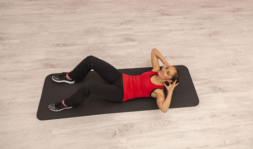 High angle view of woman lying on floor