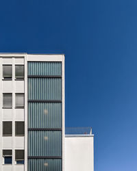 Low angle view of building against clear blue sky