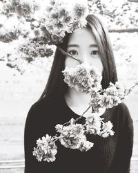 Close-up of woman holding flower