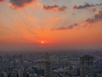 High angle view of buildings against sky during sunset