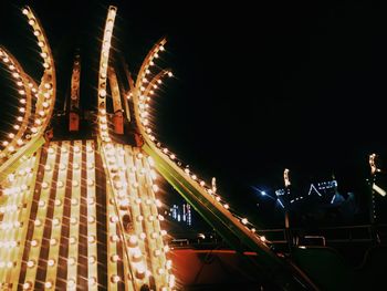 Low angle view of illuminated ferris wheel at night