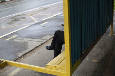 The man at the bus stop. legs of a man who is waiting for the bus. anonymous person. 