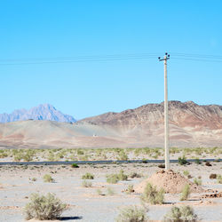 Scenic view of desert against clear blue sky