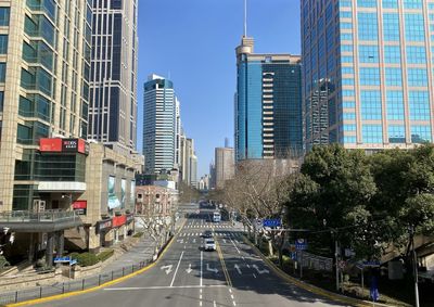 City street and modern buildings against sky