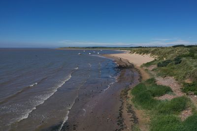 Scenic view of beach against clear sky