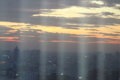 Close-up of cityscape against sky during sunset