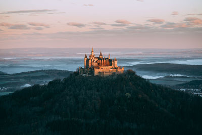 Panoramic view of traditional building against sky during sunset