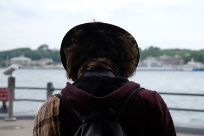 Rear view of woman looking at camera