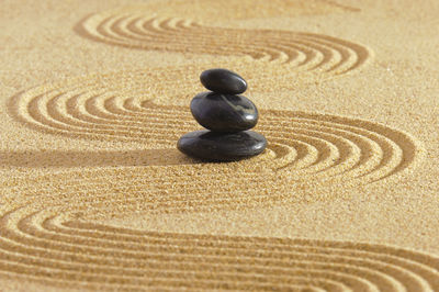 Close-up of pebbles on sand