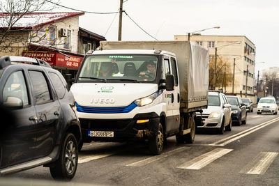 Cars parked on road by buildings in city