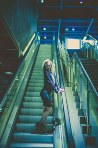 Low angle view of young woman on stairs