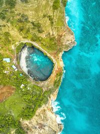 Aerial view of land by sea