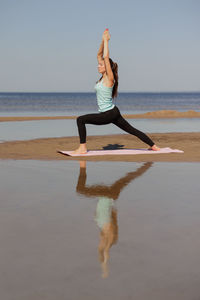 Full length of woman standing at beach