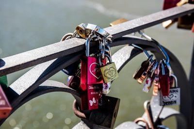 Close-up of padlocks on railing over sea