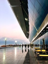 People at illuminated city against sky