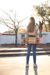 Rear view of woman standing on street