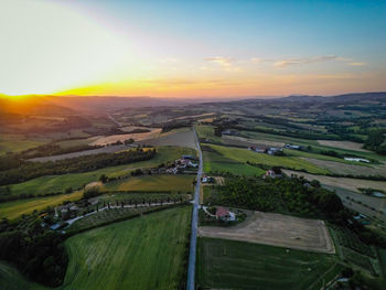 High angle view of agricultural field against sky during sunset