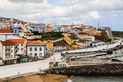Buildings against cloudy sky