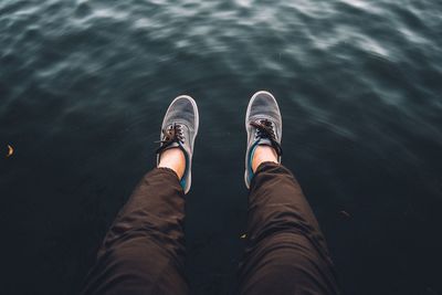 Low section of man standing in water