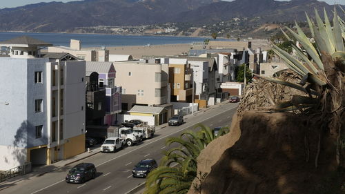 High angle view of road by buildings in city