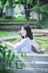 Portrait of young woman in park