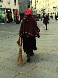 Rear view of woman holding umbrella