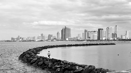 View of cityscape against cloudy sky