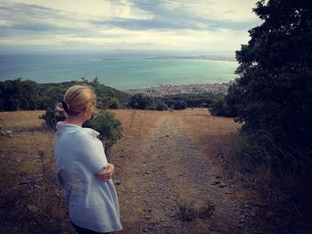 Man standing on field against sky