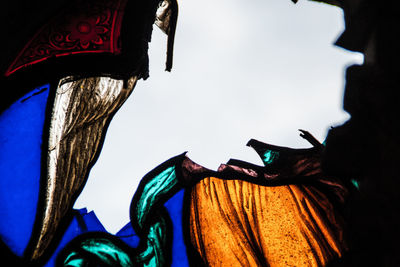 Low angle view of decorations hanging against sky