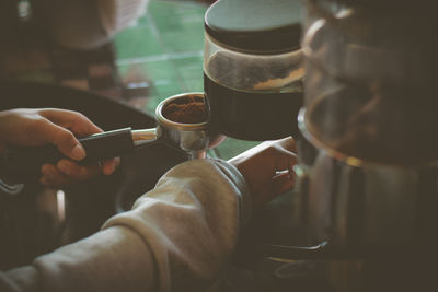 Close-up of hand holding coffee cup