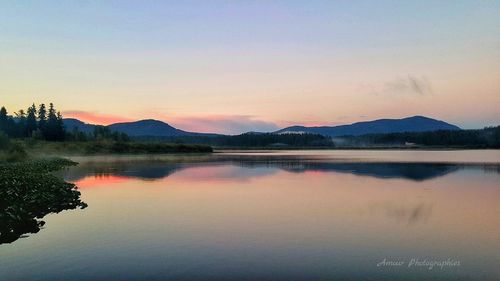 Scenic view of lake at sunset