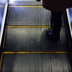 Low section of people on escalator